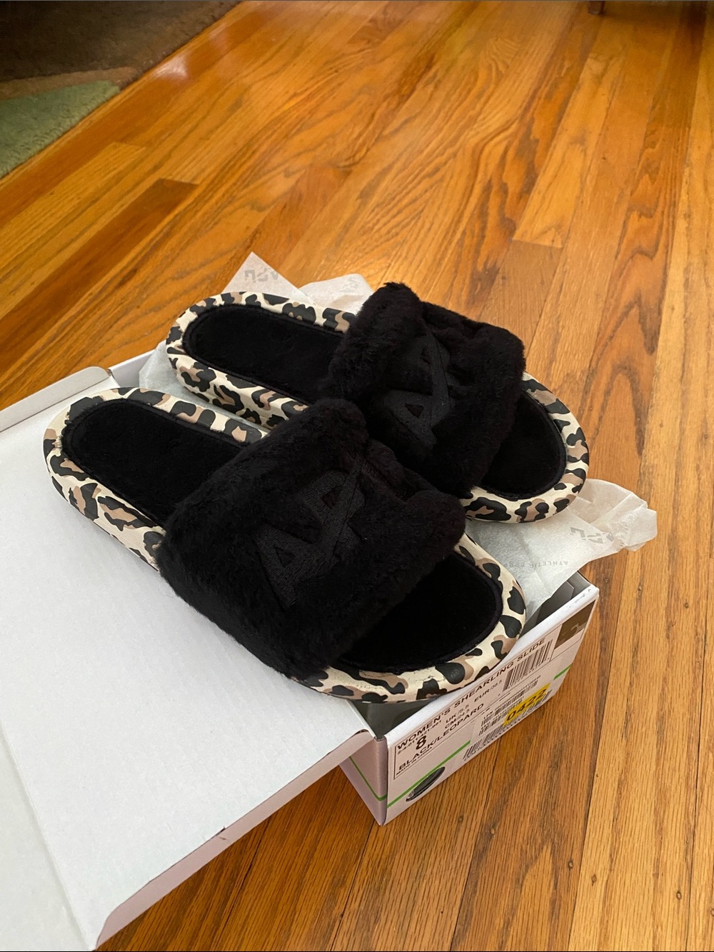 APL Athletic Propulsion Labs Shearling Slides in the Black/Leopard
